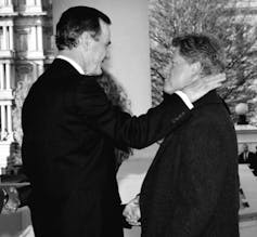 George H.W. Bush greets Bill Clinton