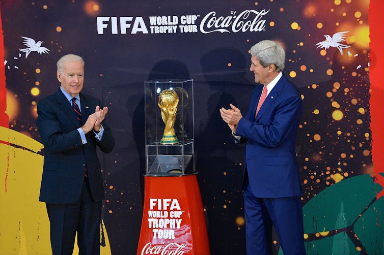 The world cup trophy surrounded by Coca-Cola advertising