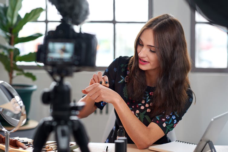 Beauty vlogger being filmed.