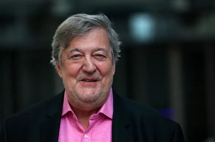 a man in a pink shirt and black suit jacket