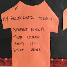 Cardboard paper cutout of a t-shirt says my reconciliation includes respect, humility, truth, courage, honesty, love