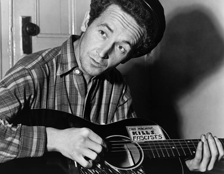 woody guthrie playing guitar