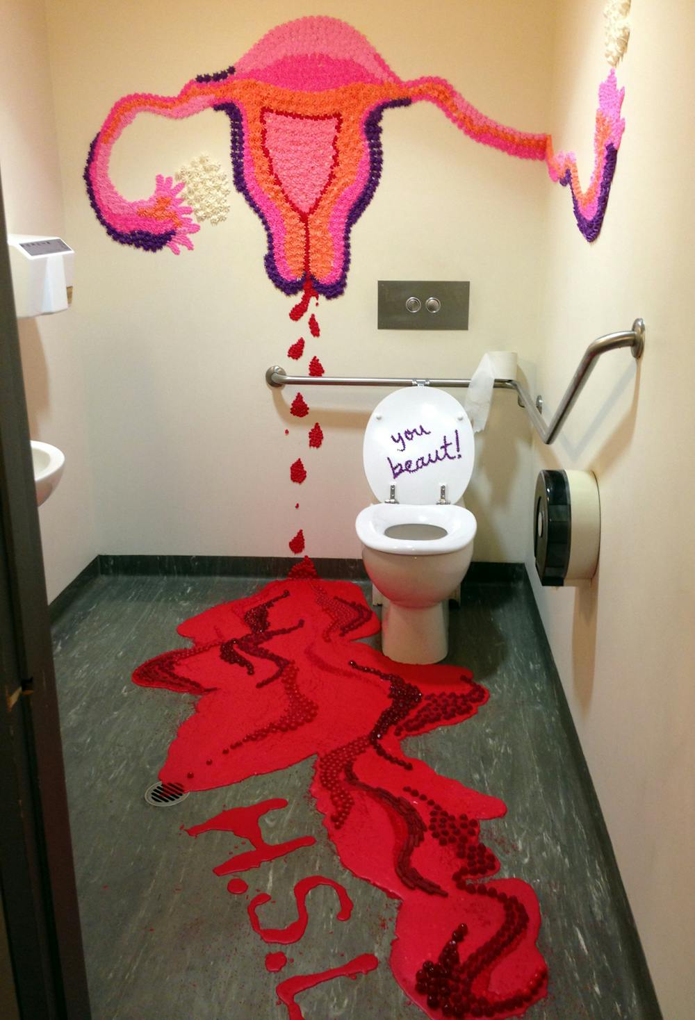Feminist artist uses red paint and MENSTRUAL PADS as canvases