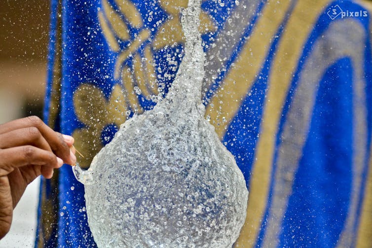 Water balloon just after it’s pricked. At this moment, water acts like a solid for a very short period. Sunil Soundarapandian/Flickr, CC BY