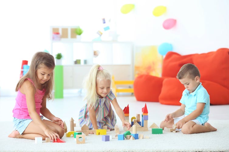 Kids learn to play and work together when using blocks.