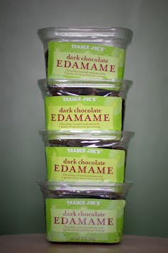 Containers of dark chocolate edamame