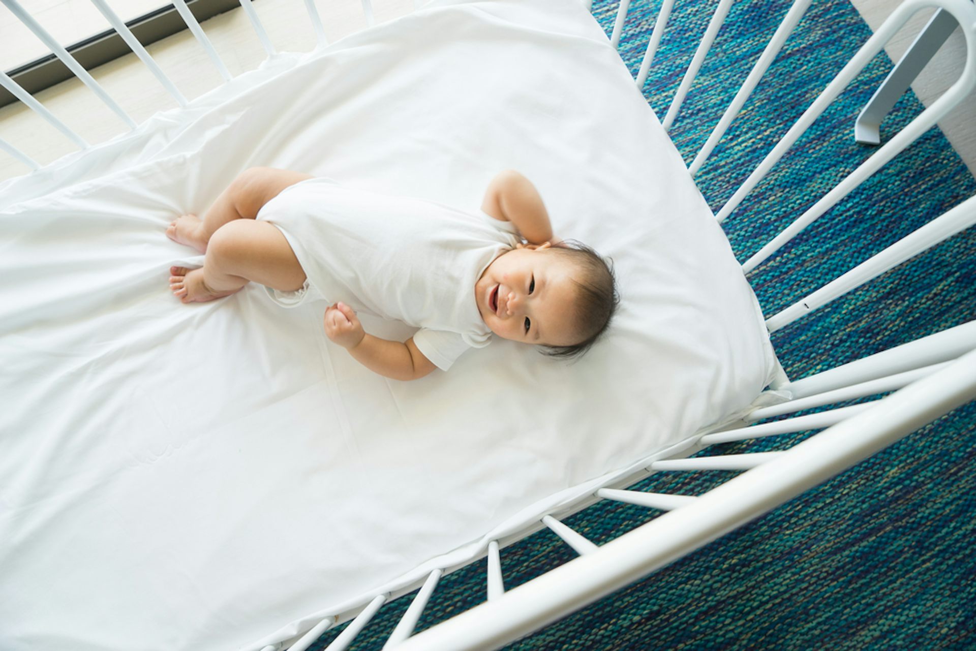 newborn rolling to side in bassinet