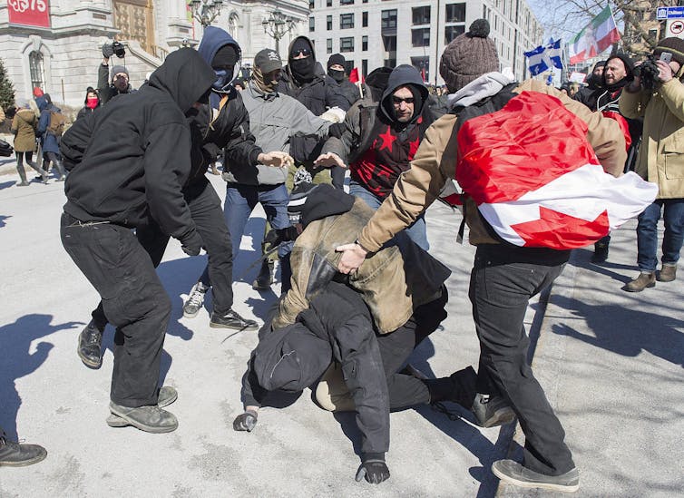 Opposing groups of protesters clash during a demonstration regarding the federal anti-Islamaphobia bill in Montreal in March 2017. THE CANADIAN PRESS/Graham Hughes