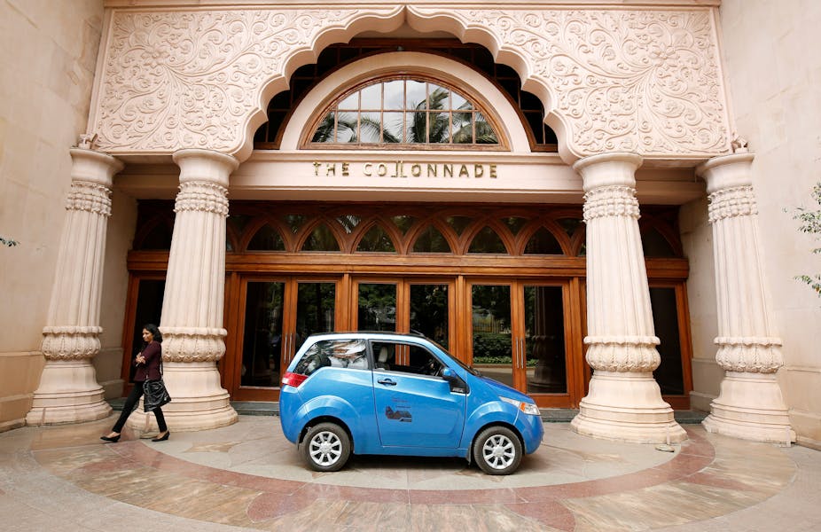 Electric Vehicles Are Changing The World And They Re Only Just A Woman Walks Past Mahindra E2o Electric Car During Media Preview In Bengaluru Reuters Abhishek Chinna