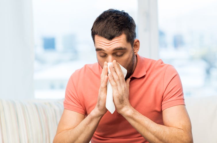 Man blowing his nose