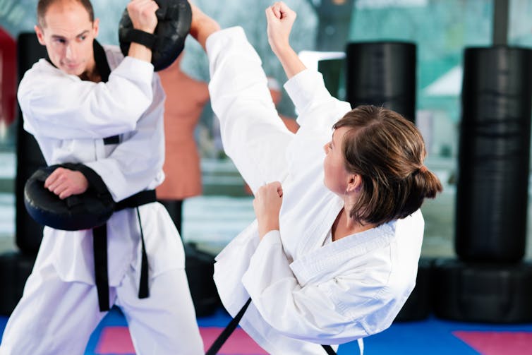 Sparring Martial arts black belts. Kzenon/Shutterstock