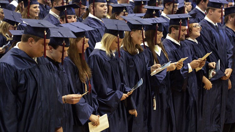 Members of the senior class of Russell County High School in Kentucky recite the Lord’s Prayer, in defiance of a court ruling, during commencement exercises in 2006. AP Photo/James Crisp