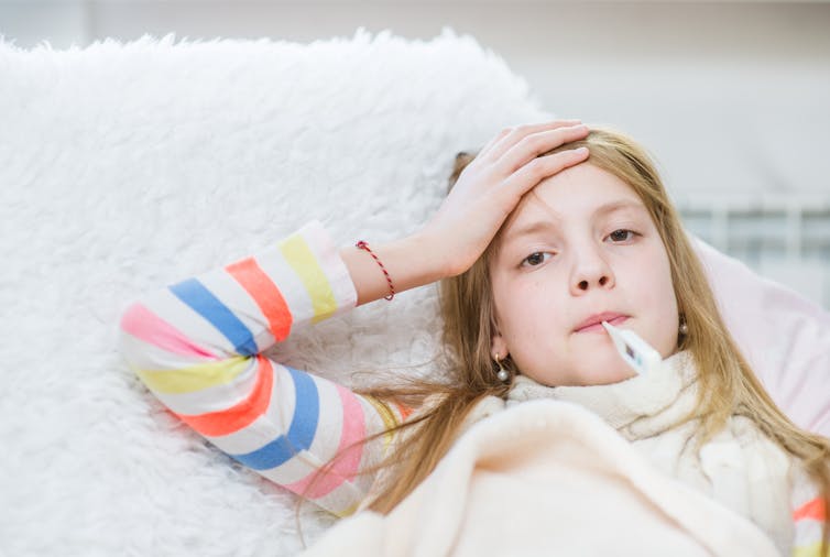 girl with thermometer in mouth