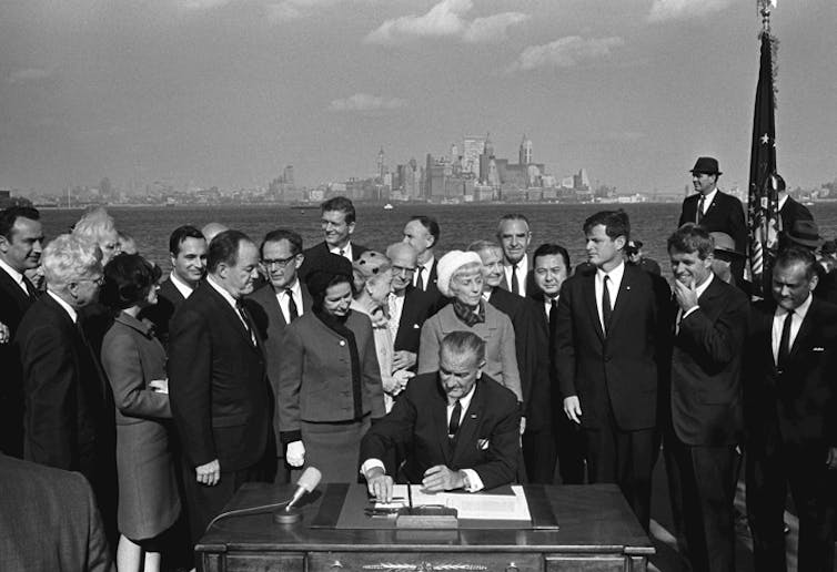 President Lyndon B. Johnson signs the Immigration and Nationality Act at Ellis Island. LBJ Library photo by Yoichi Okamoto