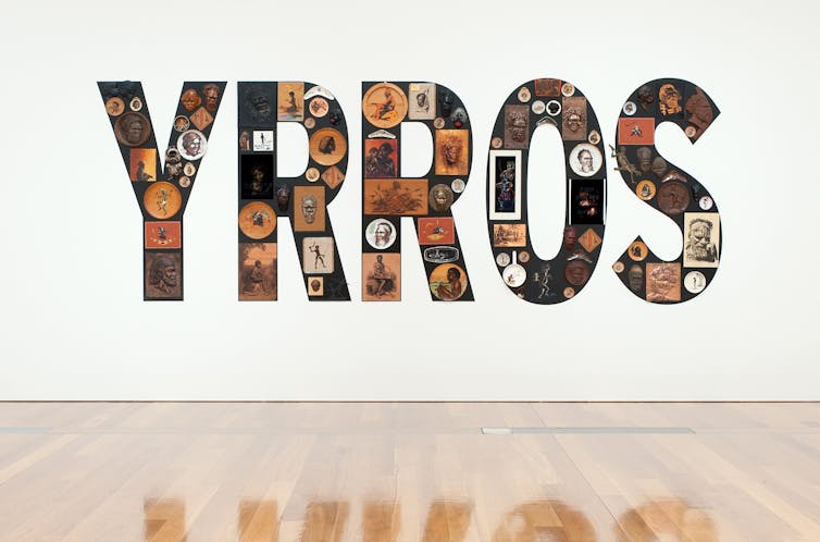 Tony Albert. Girramay/Yidinji/Kuku Yalanji peoples Australia Qld/NSW b.1981 Sorry 2008 Found kitsch objects applied to vinyl letters 99 objects: 200 x 510 x 10cm (installed) 