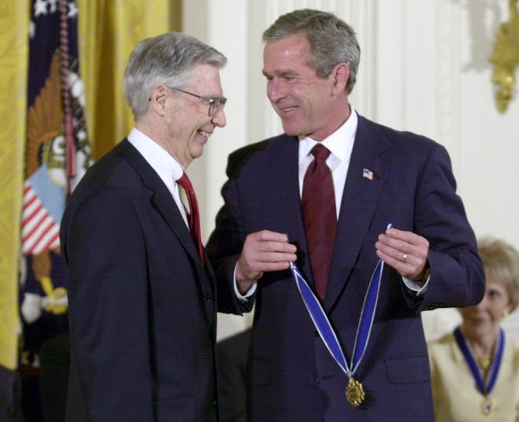 Fred Rogers with President George W. Bush, who is about to place the Presidential Medal of Freedom on Rogers in a July 9, 2002 ceremony. Kenneth Lambert/AP Photo