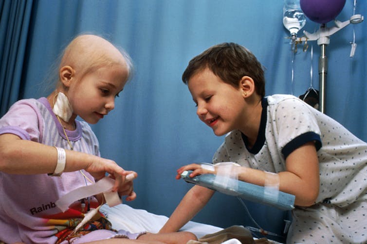 Pain: Two girls with cancer, displaying some of the side effects of cancer treatment such as hair loss, exhibit their resilience. Bill Branson/National Cancer Institute