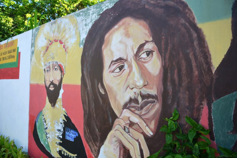 A mural depicting reggae music icon Bob Marley, right, and former Ethiopia’s Emperor Haile Selassie decorate a wall in the yard of Marley’s Kingston home, in Jamaica. AP Photo/ David McFadden