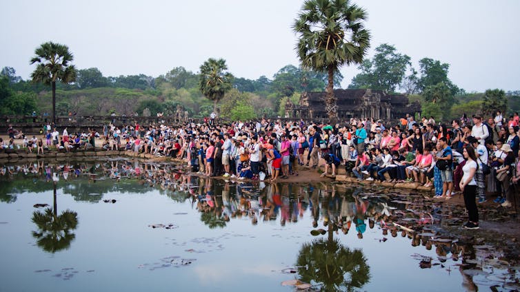 TOURIST MAGNET. Tourists take a photo of sunrise at Angkor Wat in 2016. Shutterstock 