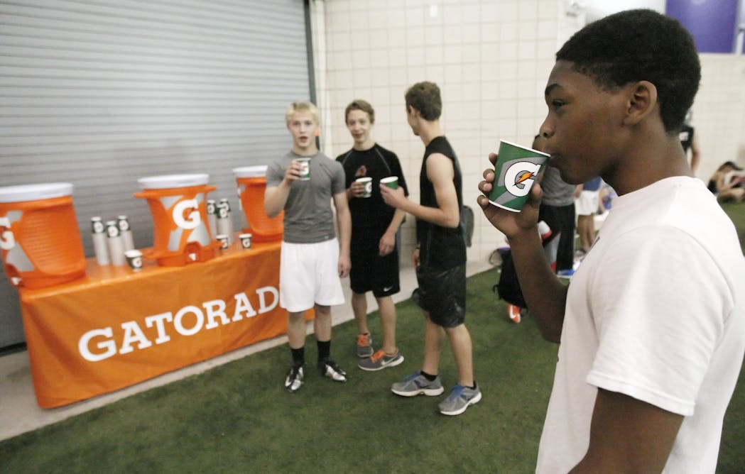 football players drinking gatorade