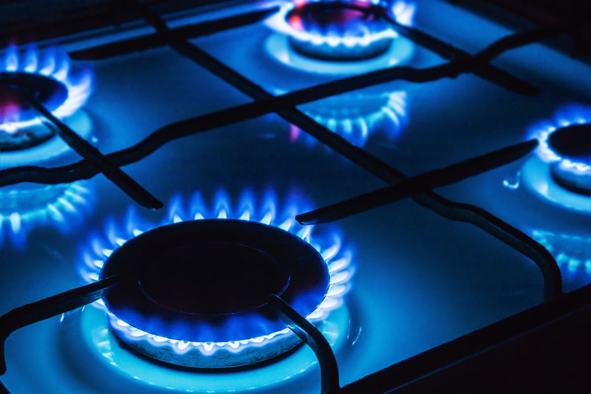 A gas stove with blue flames.