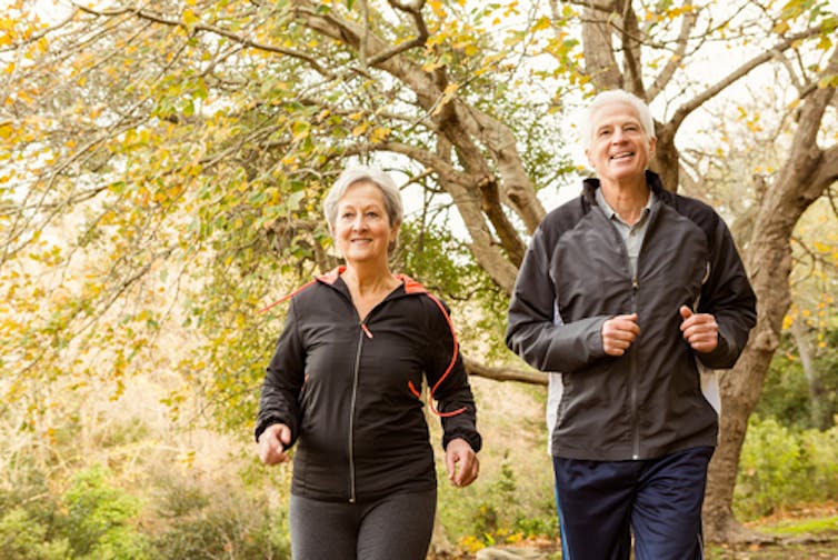 man and woman walking in the fall