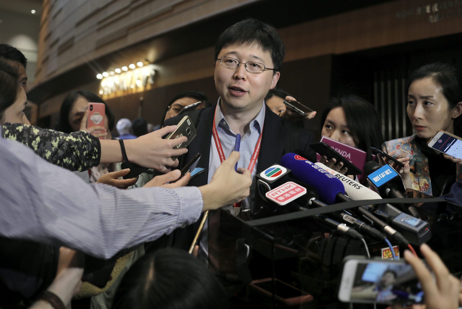 Feng Zhang, center, an institute member of Harvard and MIT’s Broad Institute, reacts to reporters on the issue of world’s first genetically edited babies after the Human Genome Editing Conference in Hong Kong on Nov. 27, 2018. (AP Photo/Vincent Yu)
