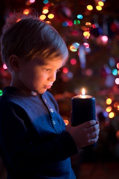 a child holding candle