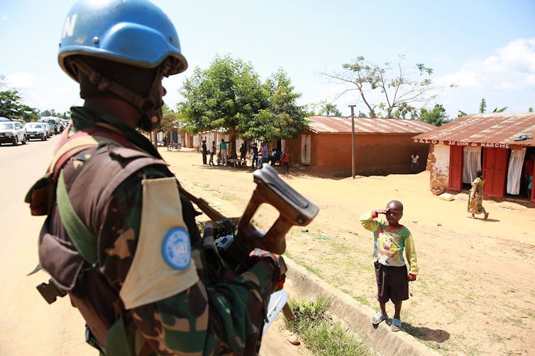 A Congolese child saluting a MONUSCO peacekeeper