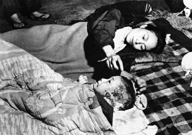 A mother and her child in the aftermath of the atomic bomb dropped on Hiroshima.