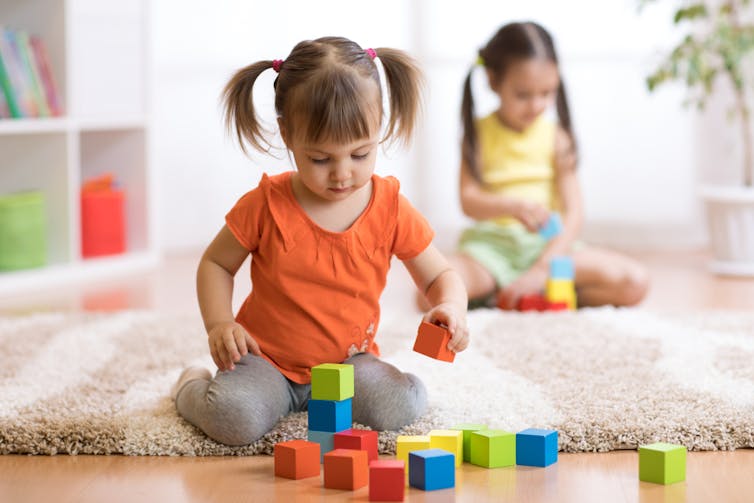 SOCIAL SKILLS. At two to 3 years, children should be able to play alongside other children with the same toys. www.shutterstock.com