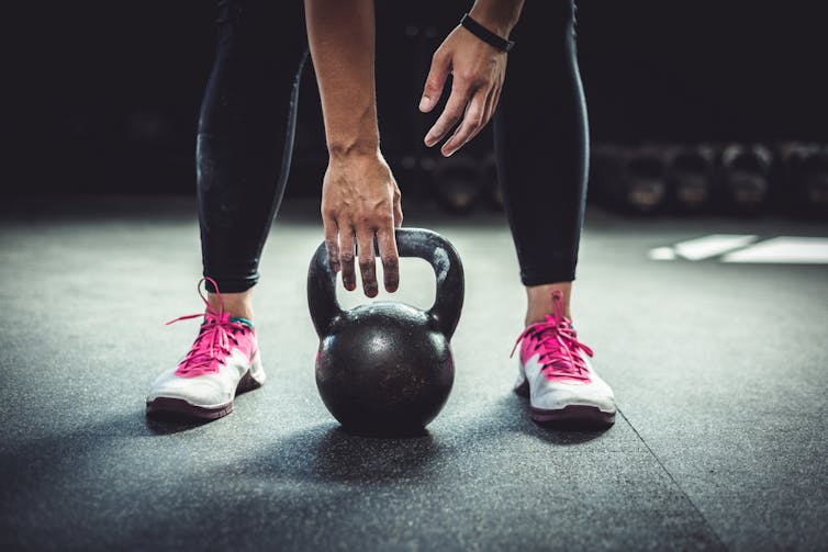 lady-about-to-lift-kettle-bell-exercising-for-her-age