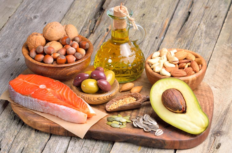 BALANCED MIX. A mix of fats, such as those found in nuts, avocados, salmon and olives, could be healthy and more satisfying. Craevschii Family/Shutterstock.com 