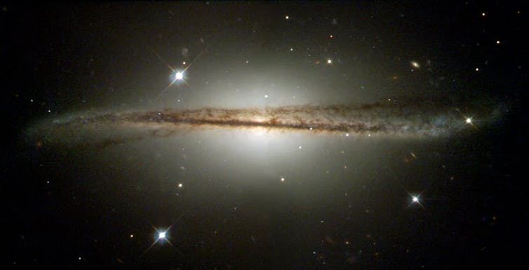 WARPED AND TWISTED. The warped spiral galaxy ESO 510-G13 seen edge-on. NASA 