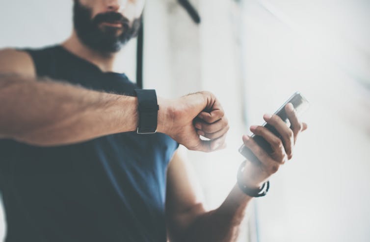 Man checking fitbit