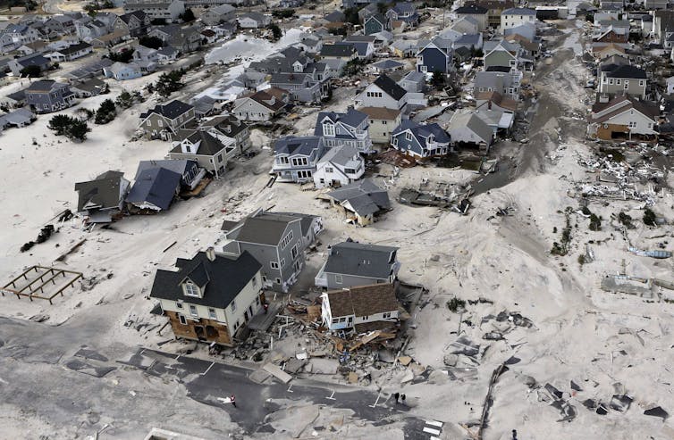 A photograph of damaged homes from a hurricane at a beach.