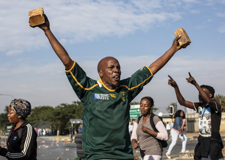 A man challenges police during a protest in Eldorado Park, Johannesburg.EPA-EFE/Kim Ludbrook A man challenges police during a protest in Eldorado Park, Johannesburg.EPA-EFE/Kim Ludbrook