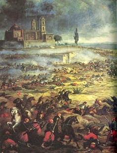 Painting of men on horseback and men in the field in a battle outside a church.