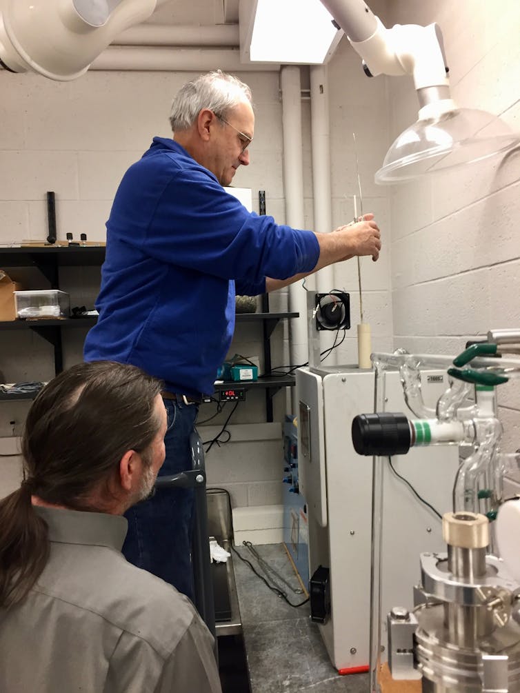 Laboratory technician Jim Zaresky (top) loads a programmable furnace as co-author Jim Greenwood looks on, in his laboratory at Wesleyan University. This is where the synthetic chondrules are made. W. Herbst