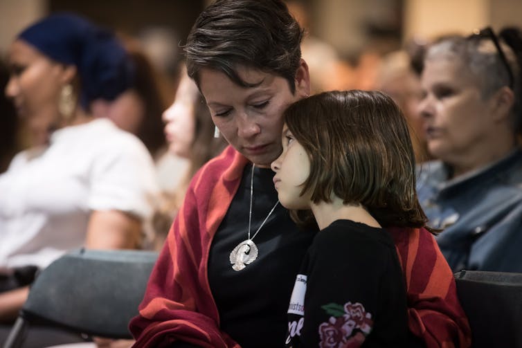 BC MLA Melanie Mark and her daughter listen as Indigenous women and allies respond to the MMIWG report.