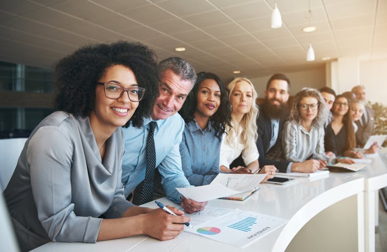 A group of people working on around an office table