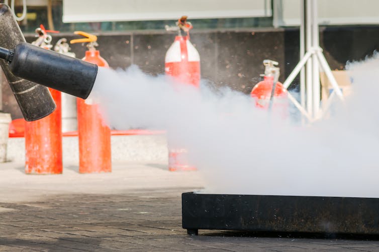 Curious Kids: How does the stuff in a fire extinguisher stop a fire?