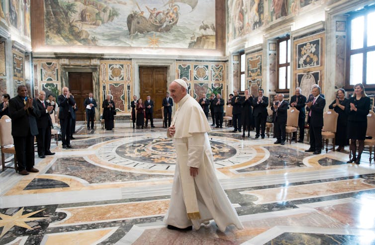 The Pope walking through Vatican