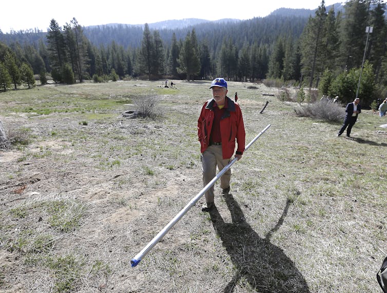 Frank Gehrke, chief of the California Cooperative Snow Surveys Program, carries a snow pack measuring tube near Echo Summit, Calif., on April 1, 2015 – the first time Gehrke found no snow at this location on this date. Source: AP Photo/Rich Pedroncelli             