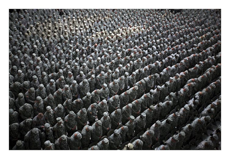 Ashley Gilbertson 1,215 American soldiers airmen marines and sailors pray before a pledge of enlistment on July 4 2008