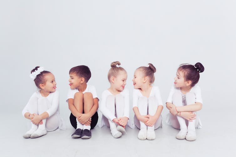 Little girls in ballet outfits with one boy