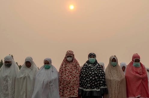 Kết quả hình ảnh cho A mass prayer for rain to combat the haze in Riau province, Indonesia, September 2019. AFRIANTO SILALAHI / EPA
