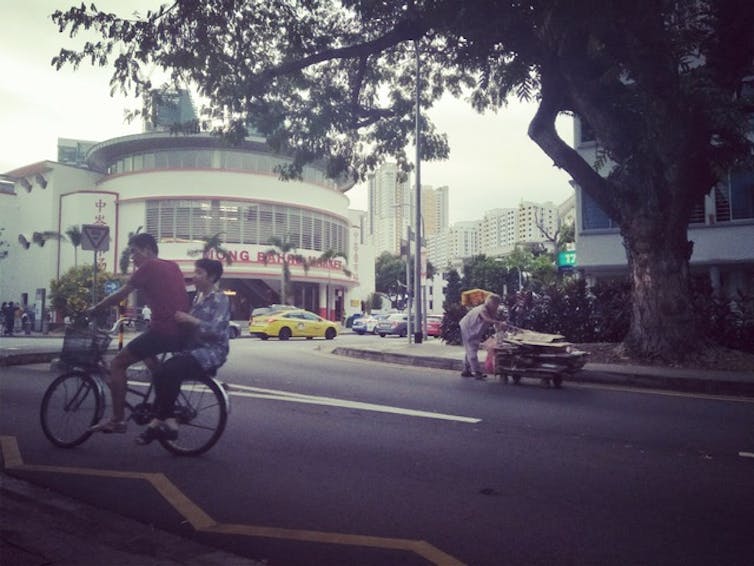 People on bike on road in Singapore 