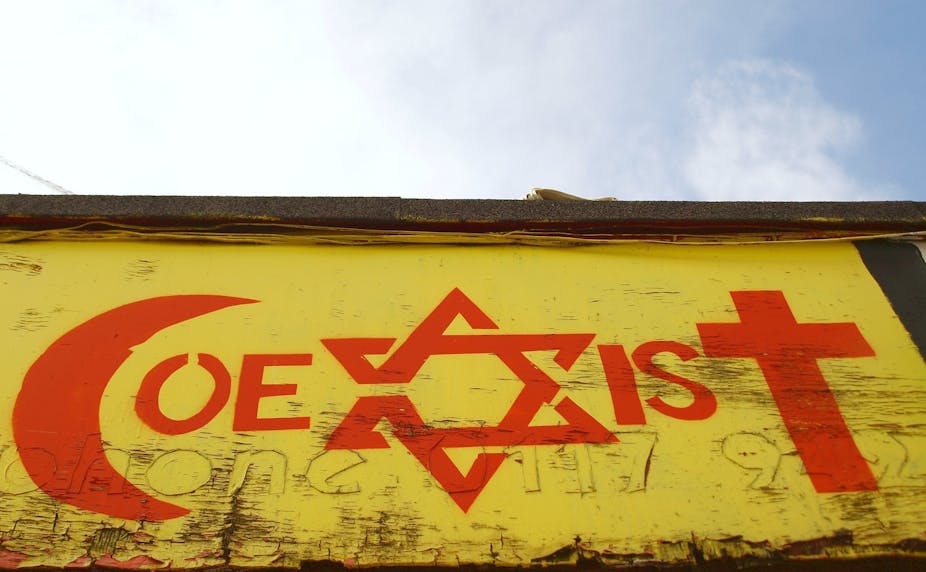 Mural of word "co-exist" with letters c,x and t replaced by religious symbols of Islam, Judaism and Christianity