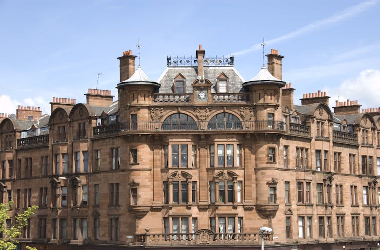 Front of old building against blue sky in Glasgow